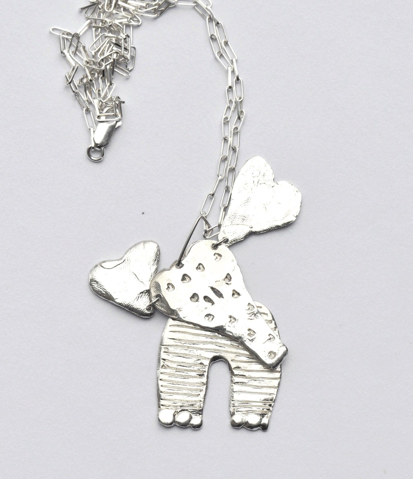 a necklace with a dog and a heart on it