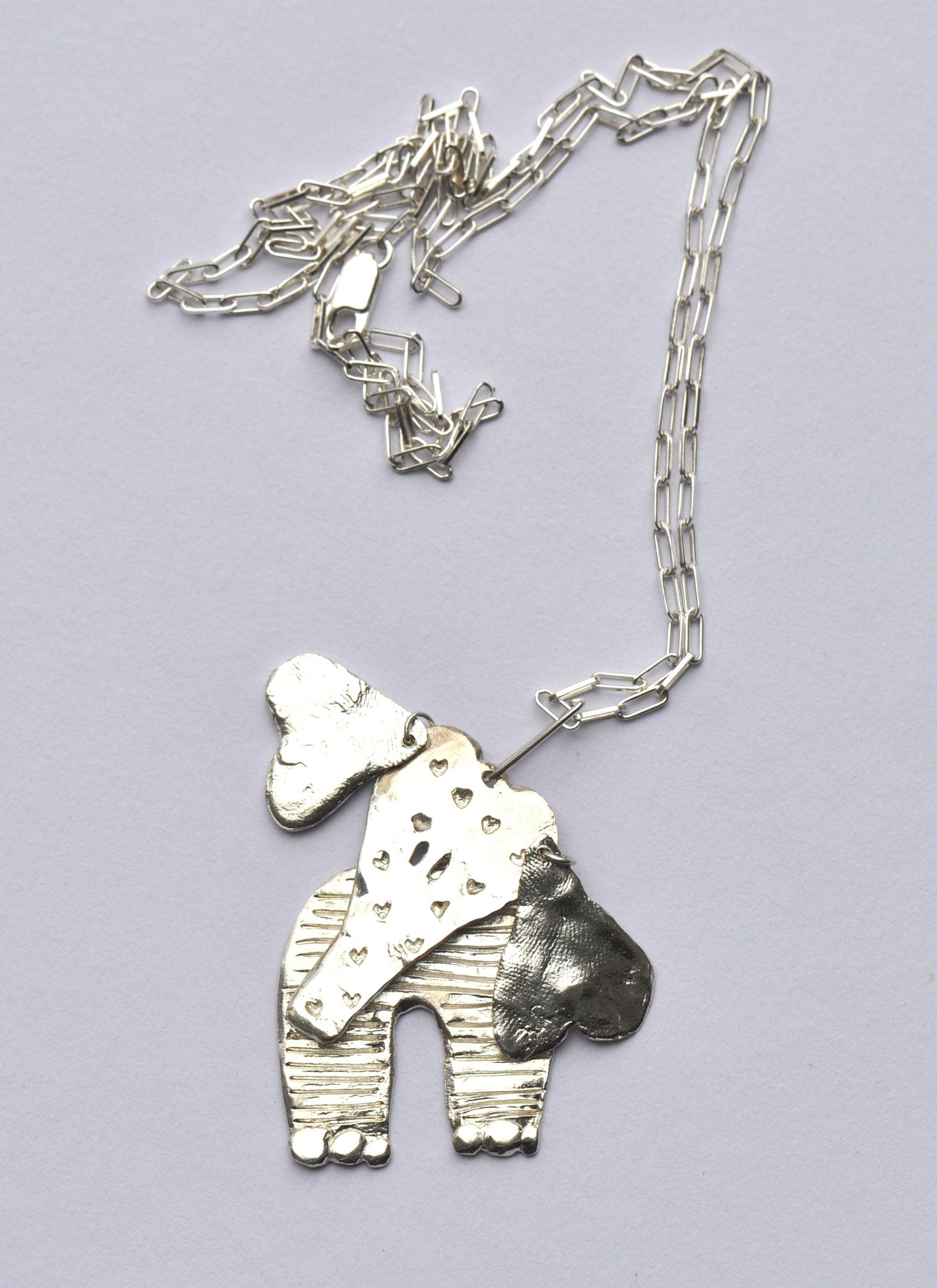 a necklace with a dog on it on a chain