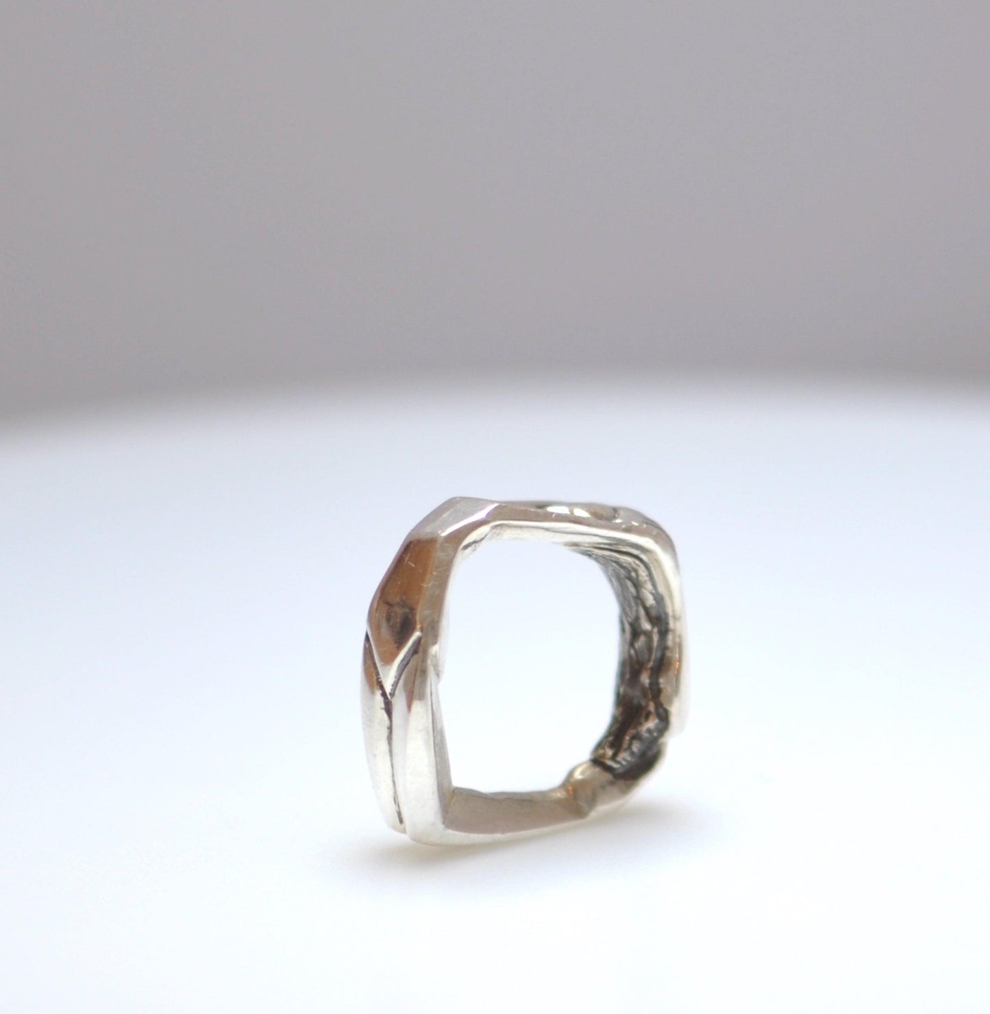 a close up of a ring on a white surface