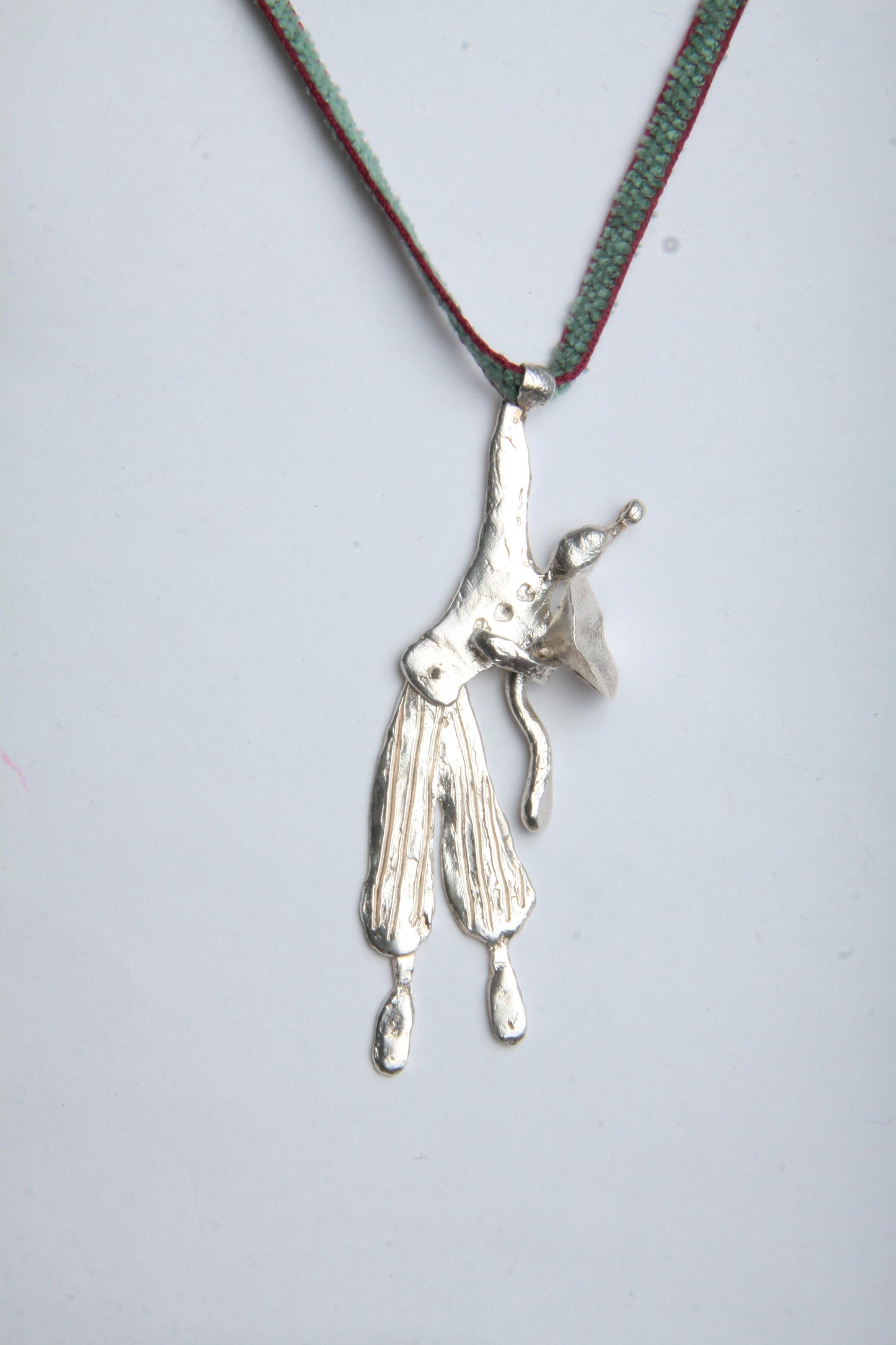 a silver necklace with a bird on it