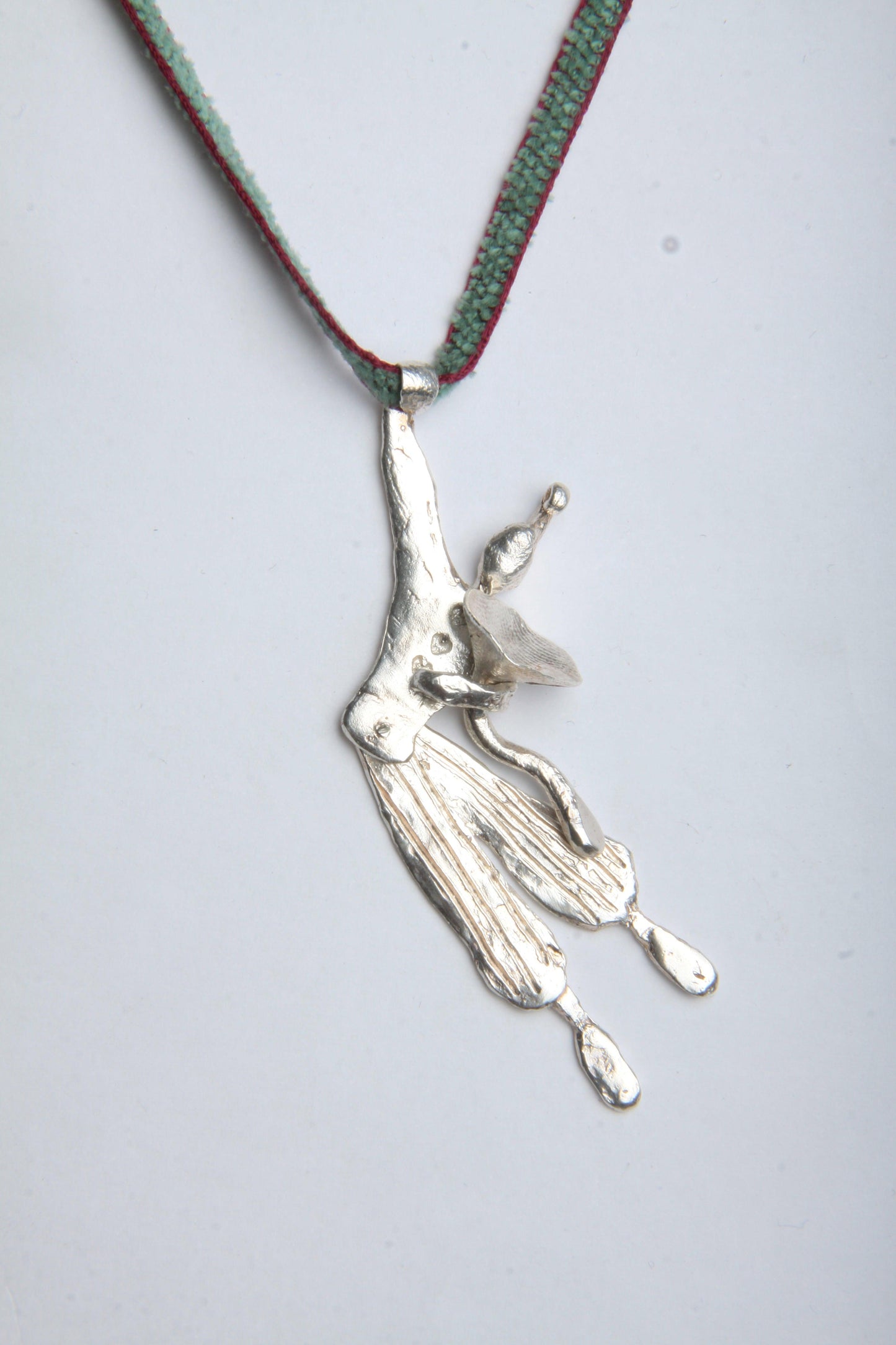 a silver necklace with a bird on it