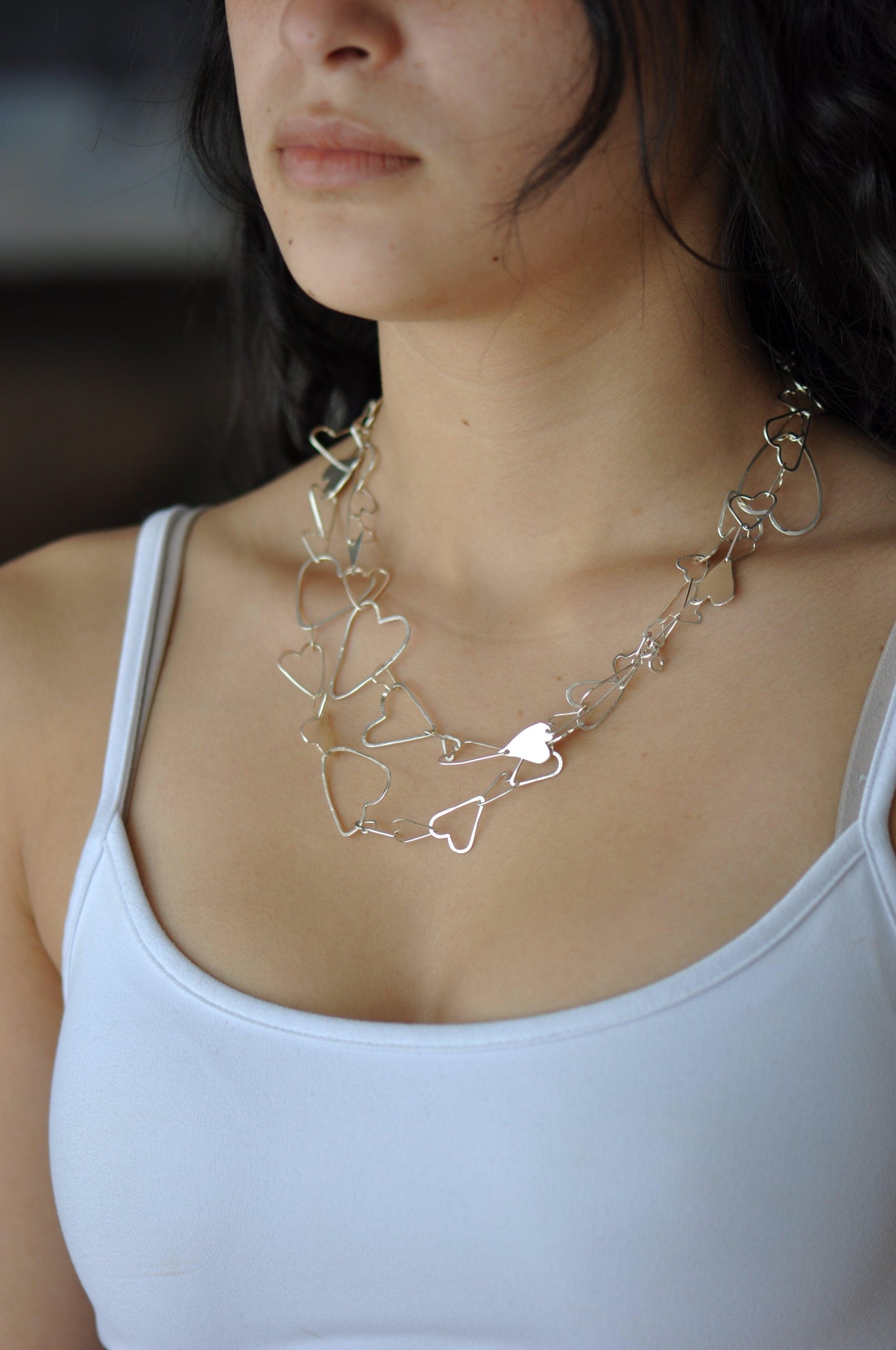 a close up of a woman wearing a necklace