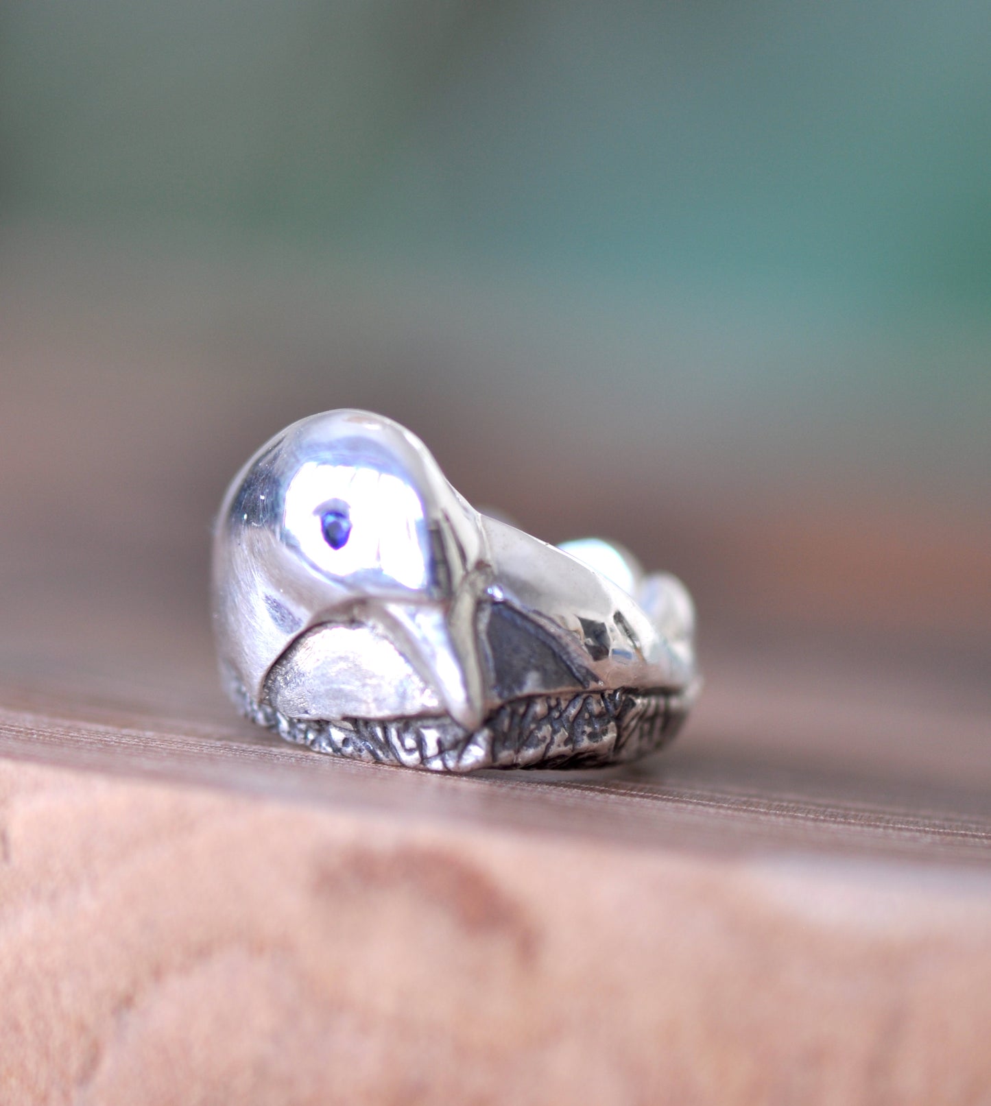 a close up of a ring with a bird on it