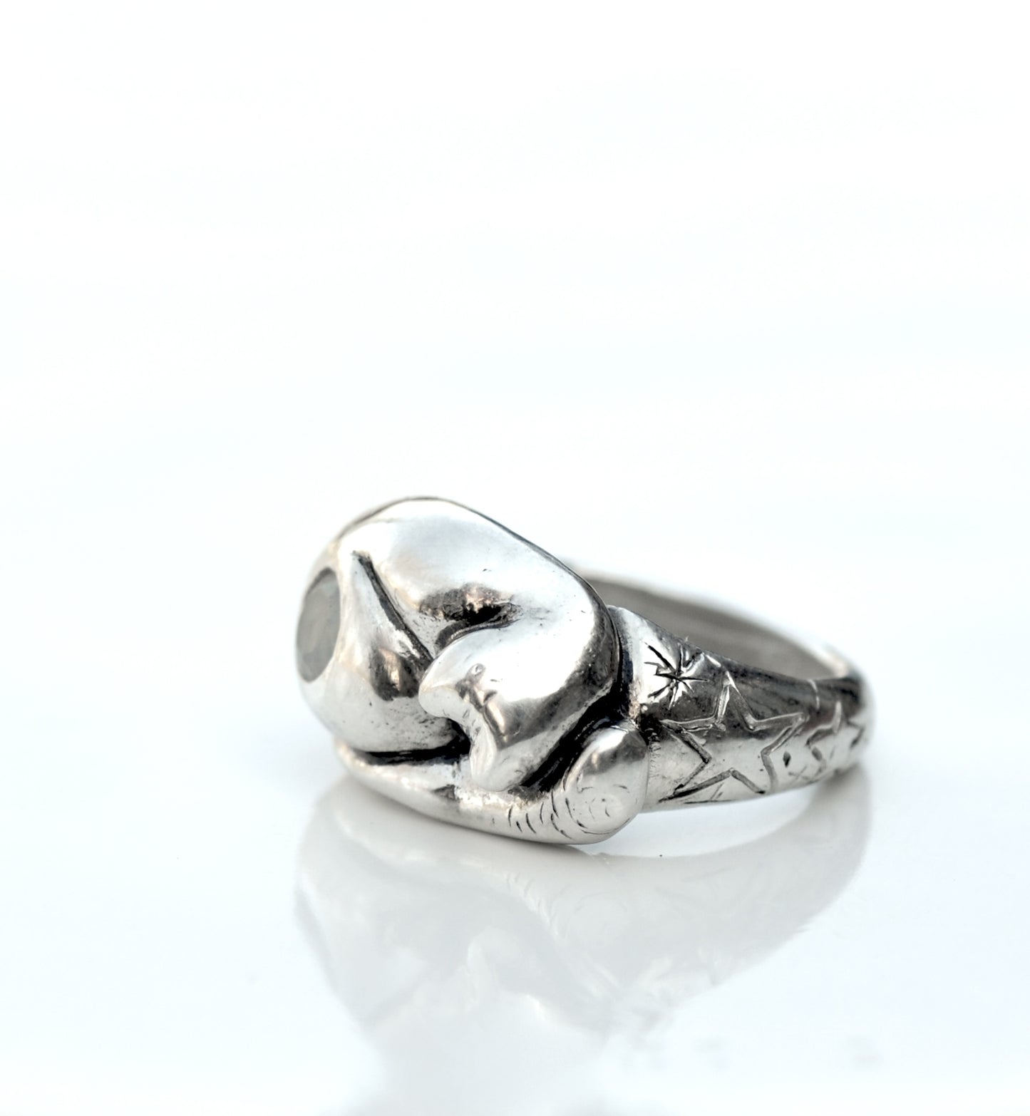 a close up of a silver ring on a white surface