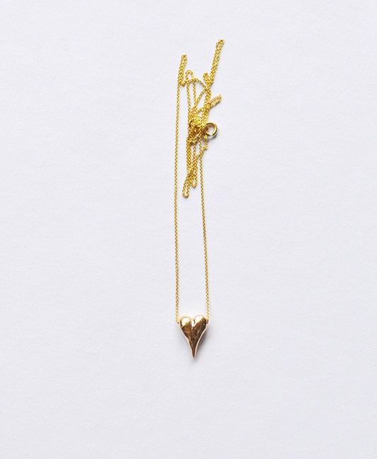 a gold necklace with a heart on a chain