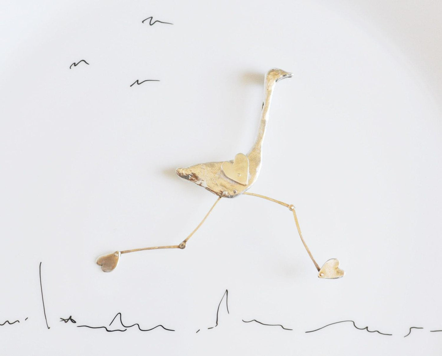 a drawing of a bird on a white plate