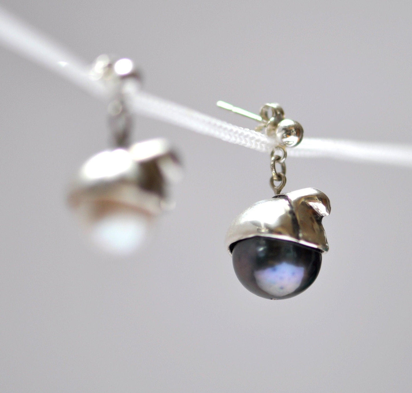 a pair of earrings hanging from a string