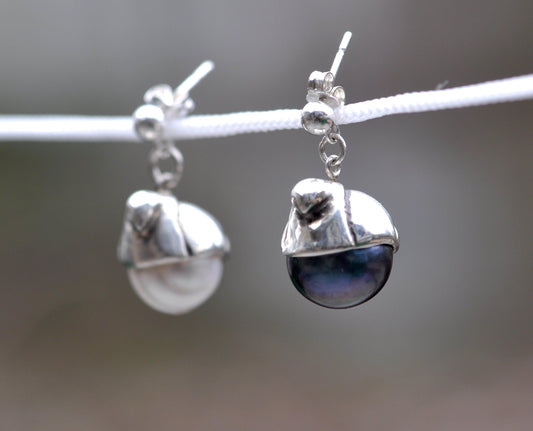 a pair of earrings hanging from a rope