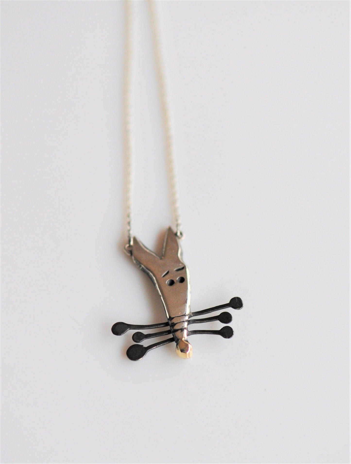 a necklace that has a cat on it