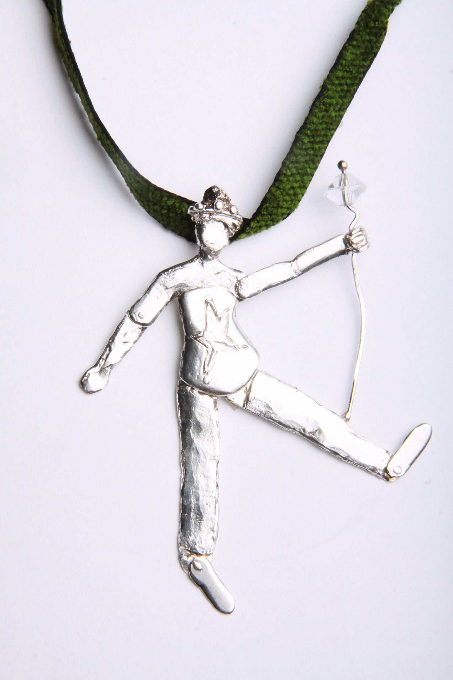 a metal figure holding a bow and arrow