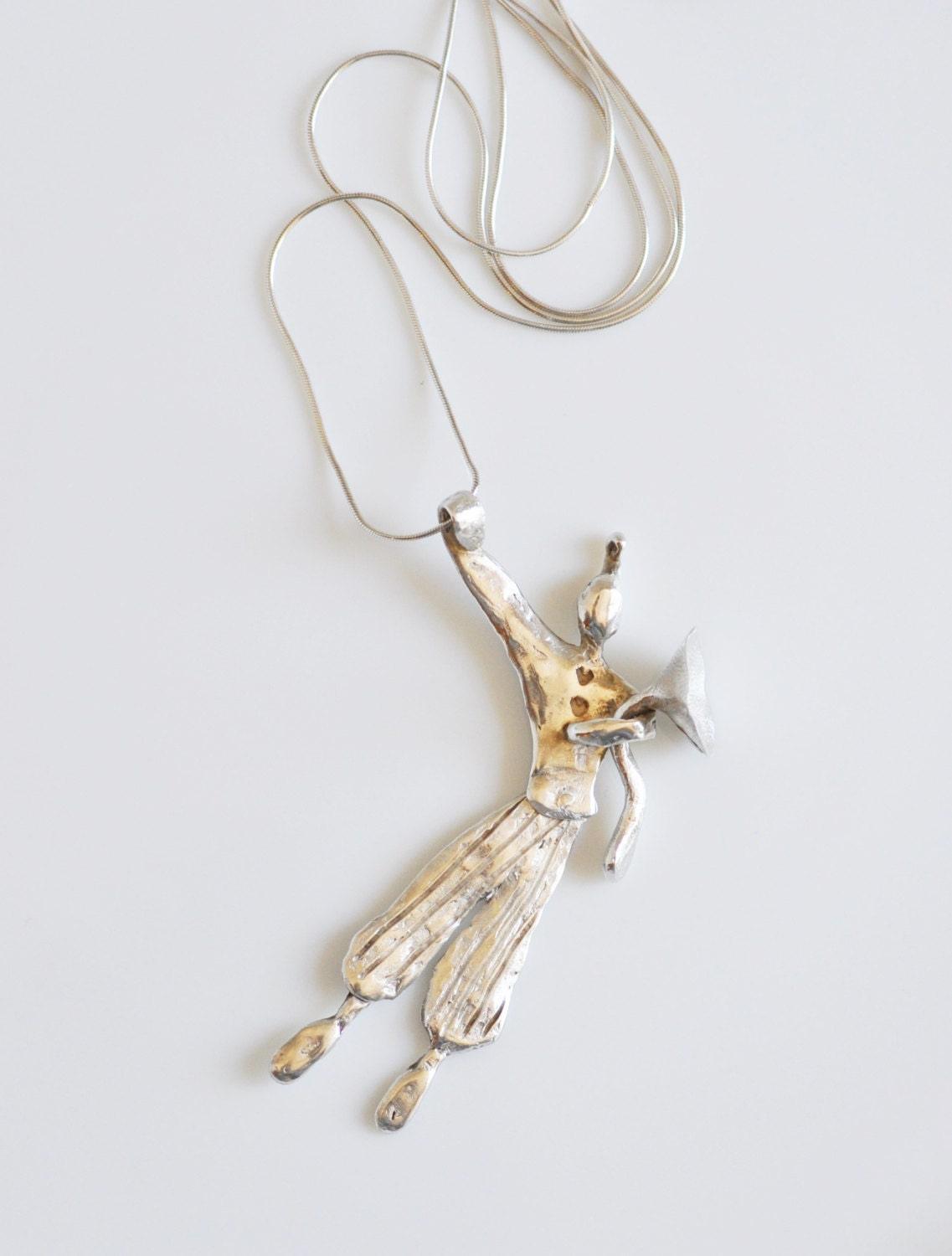 a silver necklace with a bird on it