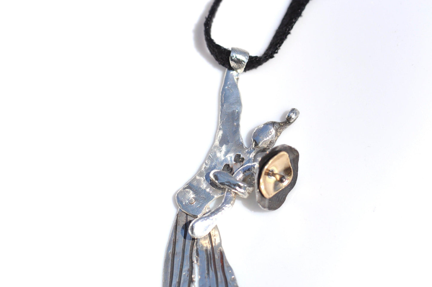 a silver and gold necklace with a bird on it