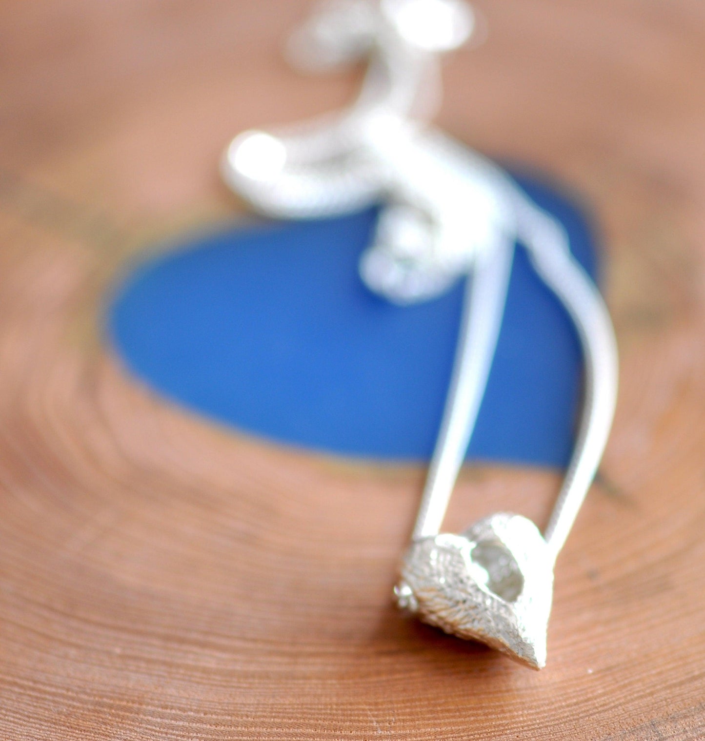 a piece of jewelry sitting on top of a wooden table