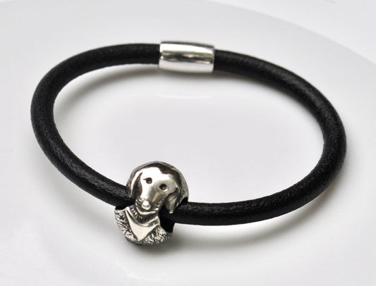 a black leather bracelet with a silver elephant head charm