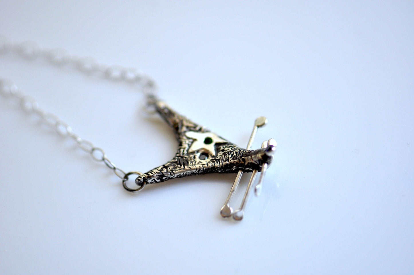 a silver necklace with a skull on it