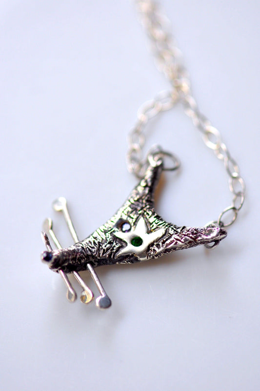 a silver necklace with a giraffe on it