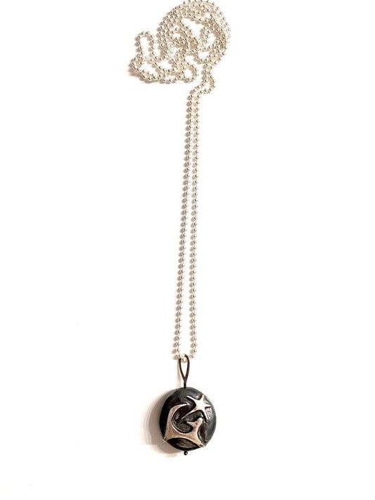 a black and white necklace with a silver chain