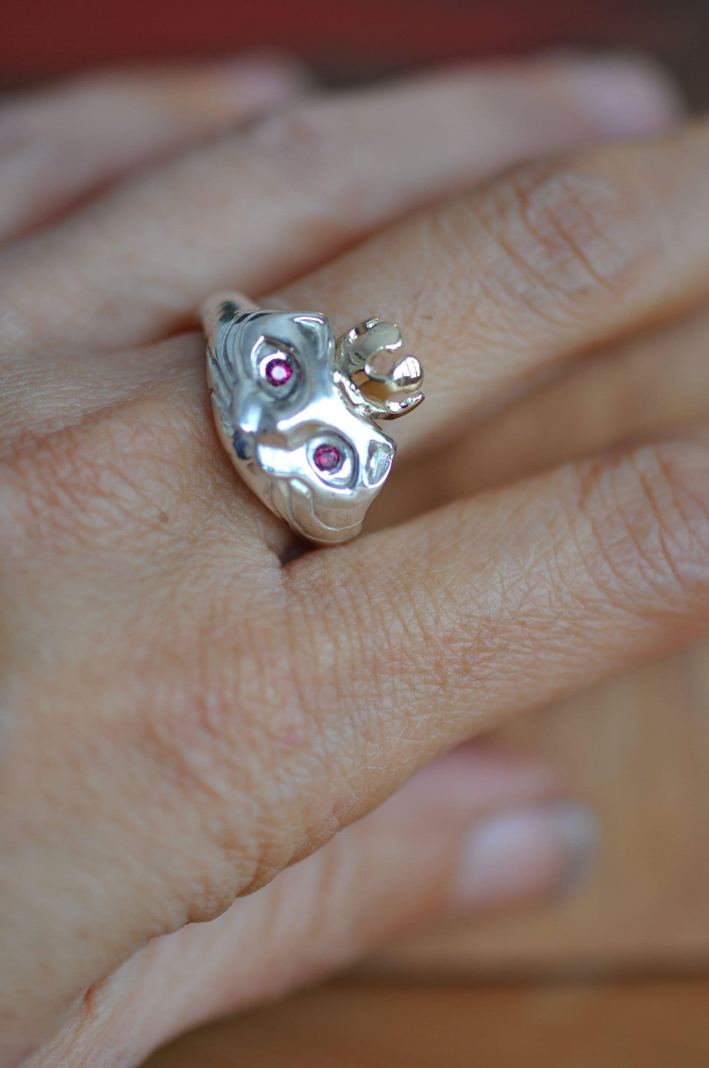 a close up of a person's hand with a ring on it