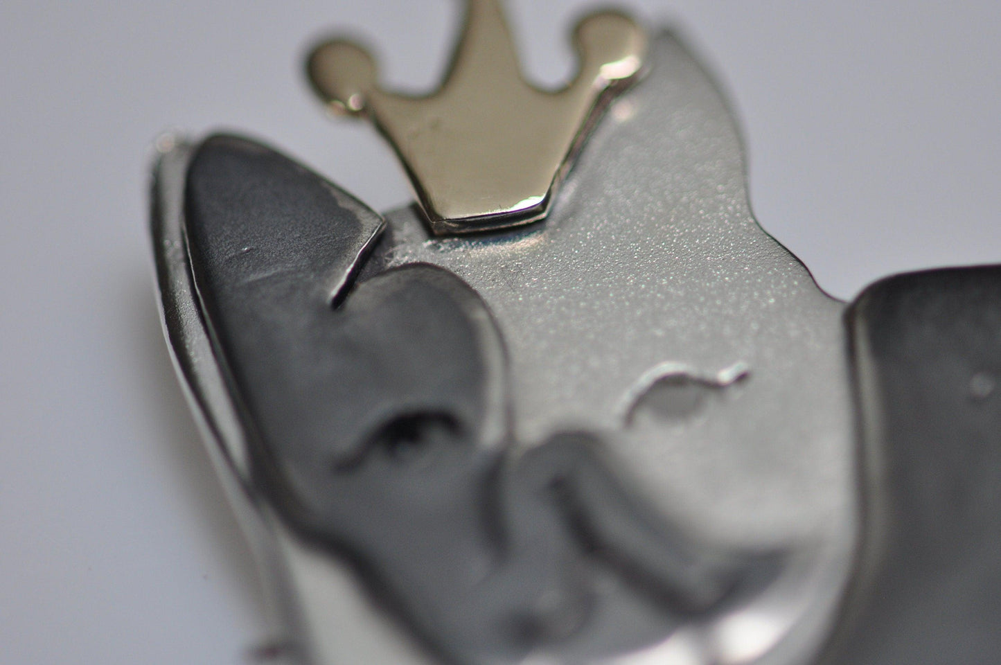 a close up of a metal object with a crown on top of it