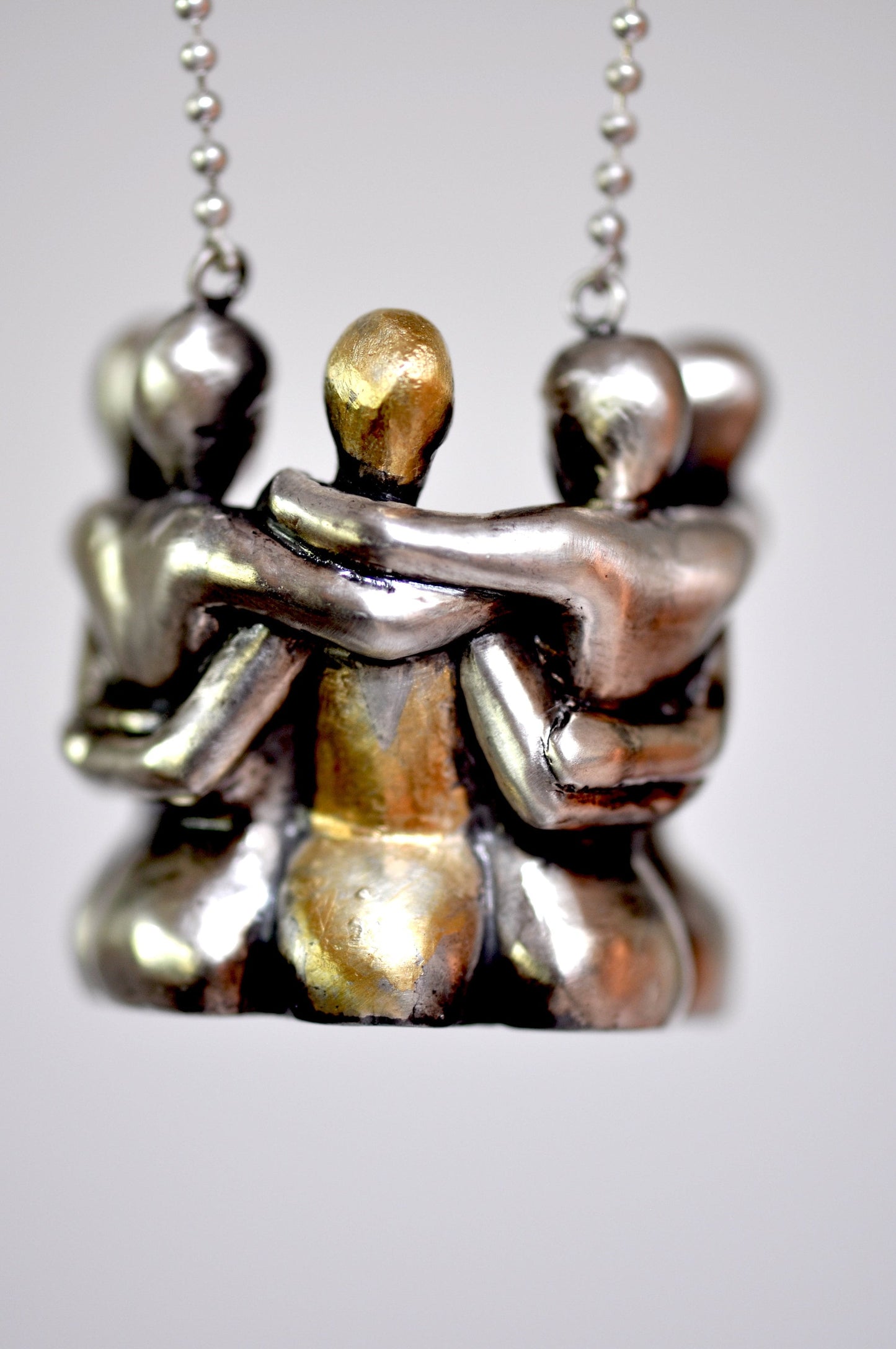 a couple of silver figurines sitting on top of each other