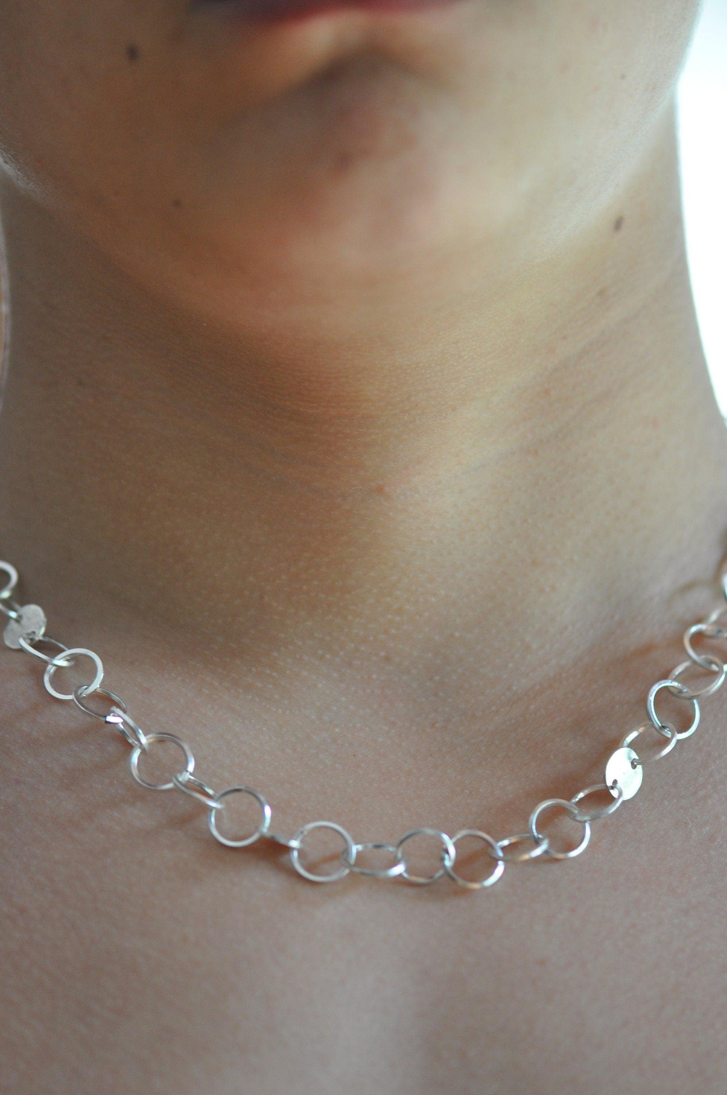 a close up of a person wearing a necklace