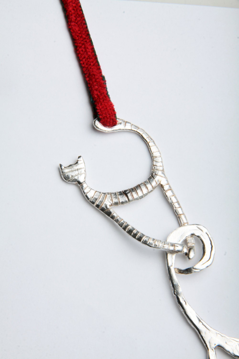 a metal object with a red cord attached to it