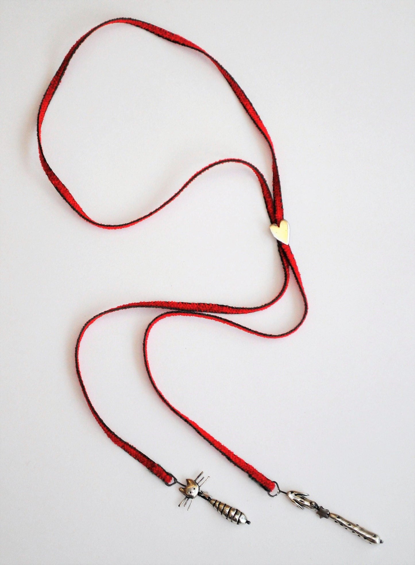 a red lanyard with a metal hook on a white background