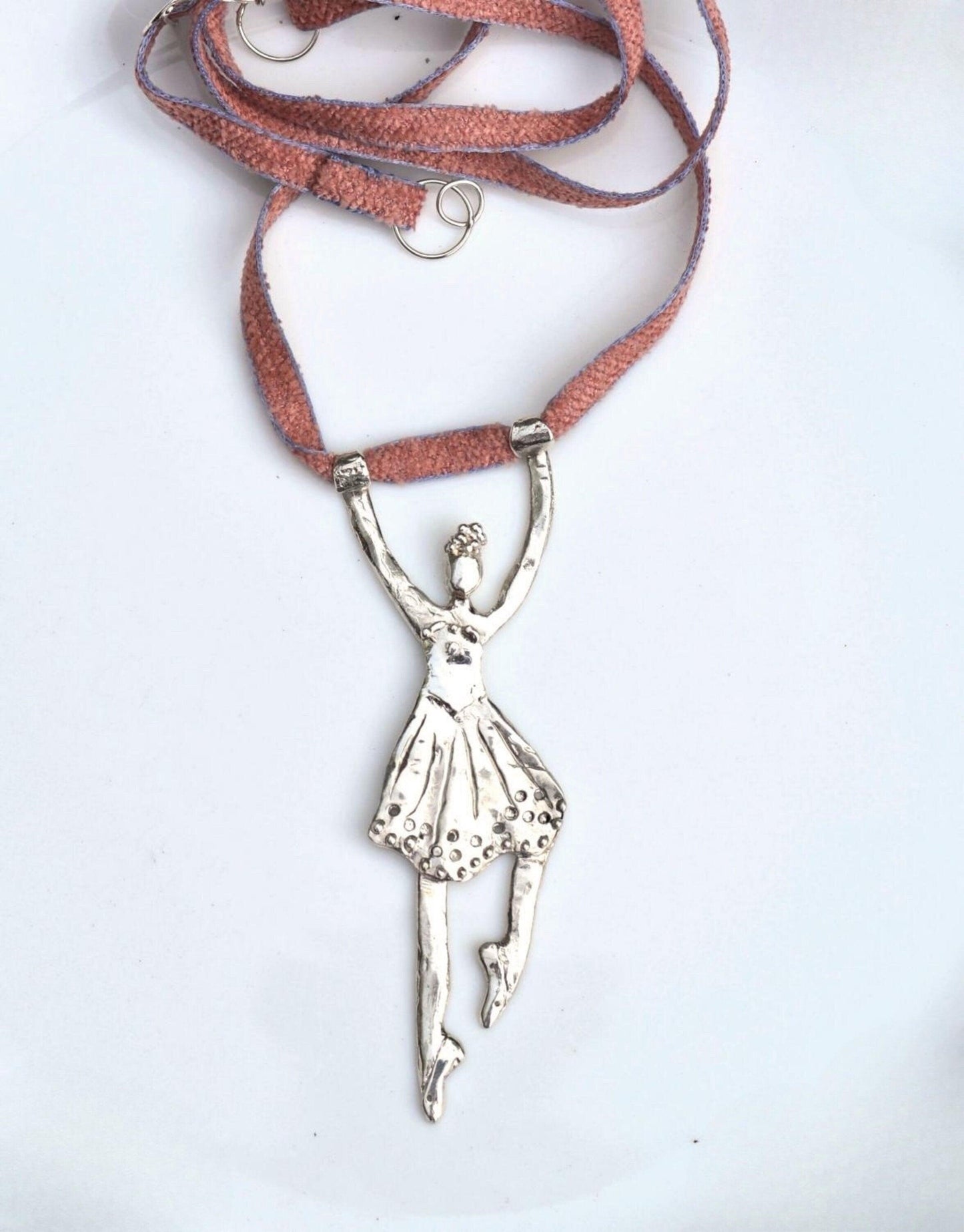 a necklace with a ballerina on it