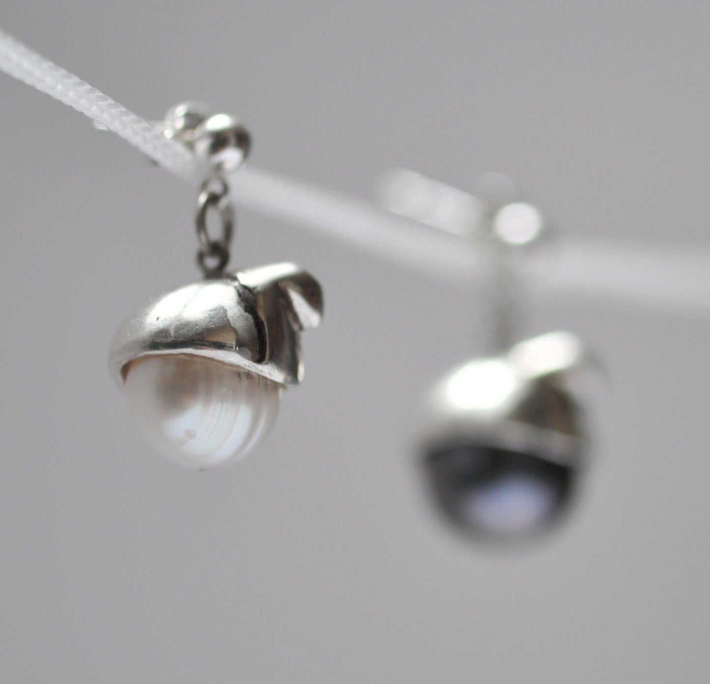 a close up of a pair of earrings on a string