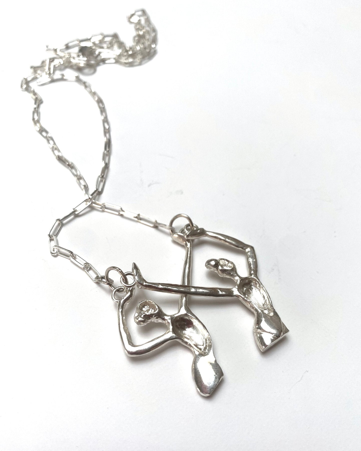 a silver necklace with a heart and a nurse's stethoscope